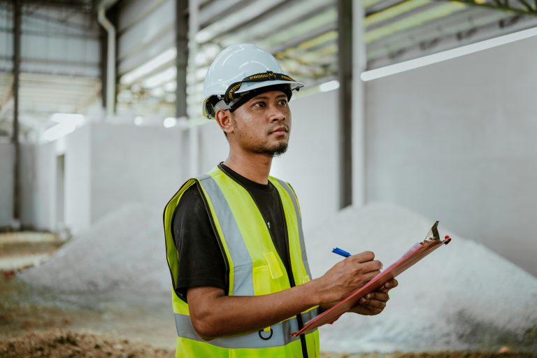 man surveying pool building site